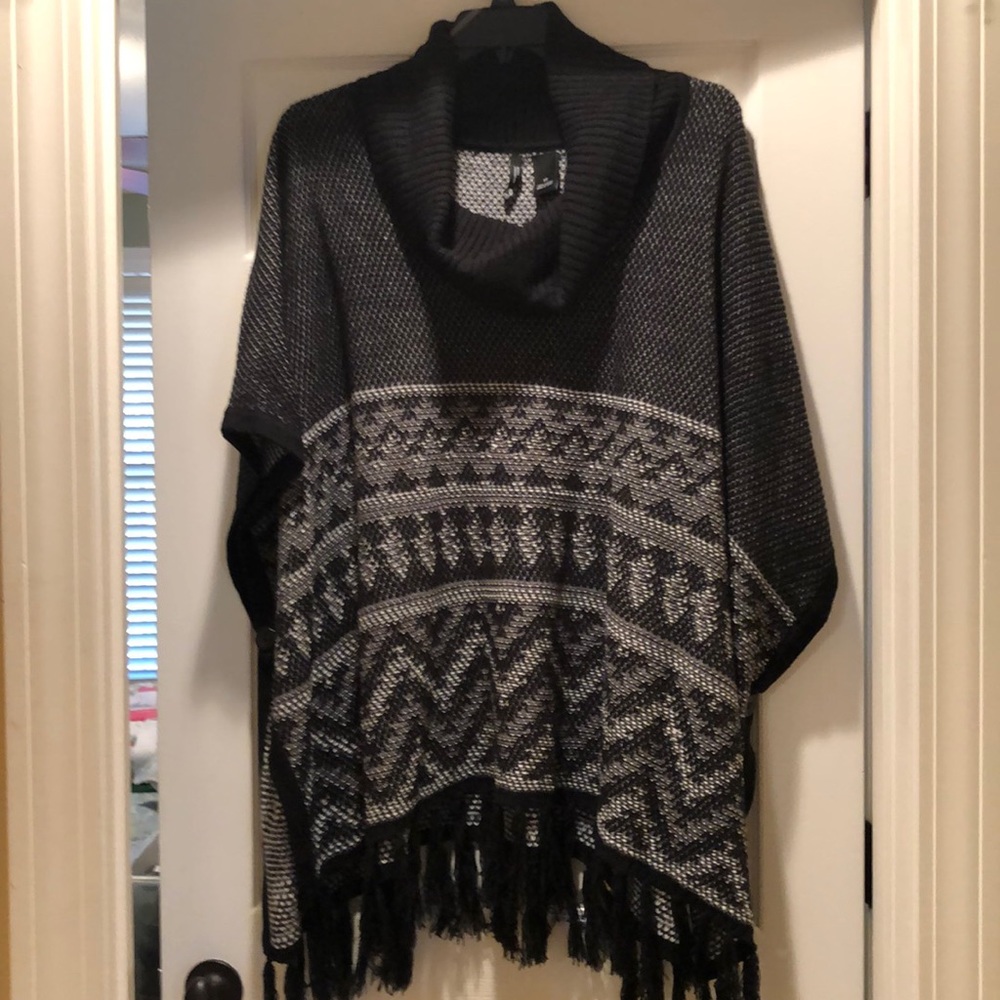 Ladies cowl neck black and white fringed poncho